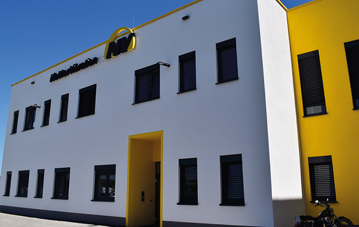 weiß, gelb, graues Gebäude vom Headquarter von Netter Vibration in Mainz-Kastel